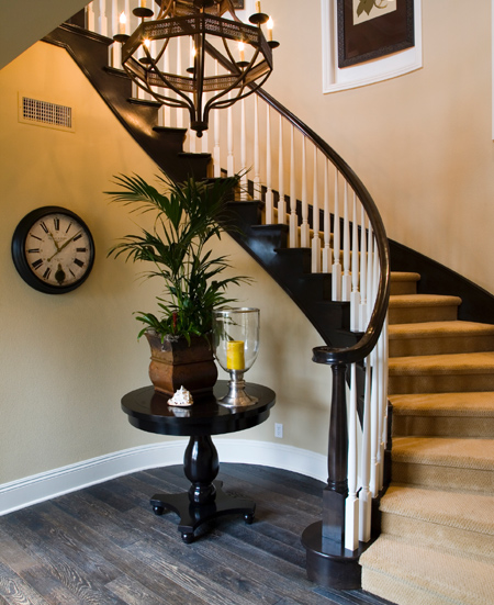 traditional staircase with curved design and balustrade