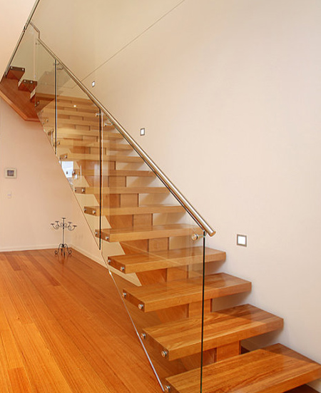 modern staircase with open glass panel side and wooden stair treads