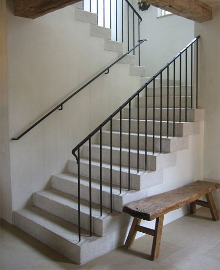 rustic traditional concrete stairs with wrought iron railing balustrade and bannister