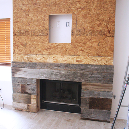 Reclaimed wood fireplace surround adding planks