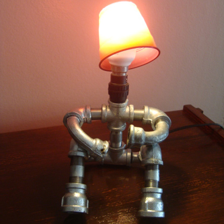 galvanised pipe men table lamps sitting down with arms bent