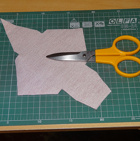 use scissors to neaten edges on fabric cellphone holder