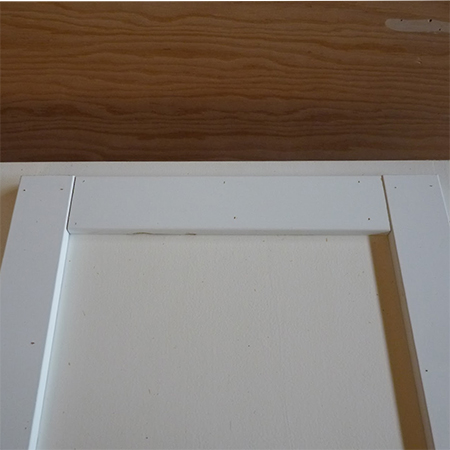 glue strips frames around plain kitchen cabinet doors for shaker style