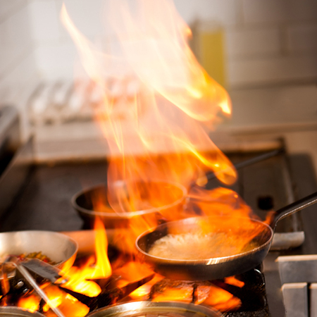 how to put out oil or grease fire in kitchen on stove or hob