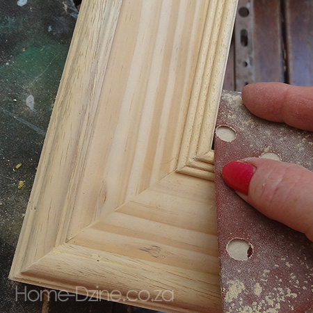 11. Use wood filler and sandpaper to touch up any areas on the frame and moulding. Sand smooth and wipe clean.