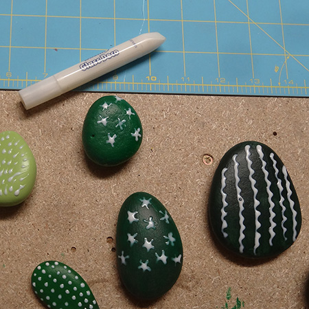 Painted pebbles for colourful cacti display