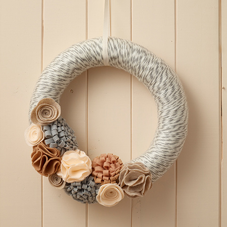 Use affordable felt to make unique holiday decor for the festive season. In this feature we show you how to make a felt wreath and felt garland.