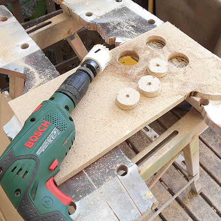 Use a corded drill (500W) to cut out support plugs for the PVC pipes using a 44mm diameter hole saw