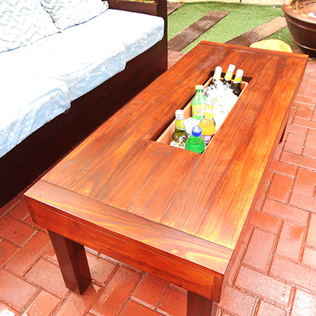 This outdoor table has a built-in ice cooler to keep all your summer refreshments cold on hot, hot days.