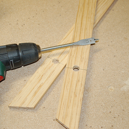 3. Use a 13mm spade bit to drill a hole at the top in all four legs. Place a wood offcut underneath where you are cutting for a neatly drilled hole on all sides. 