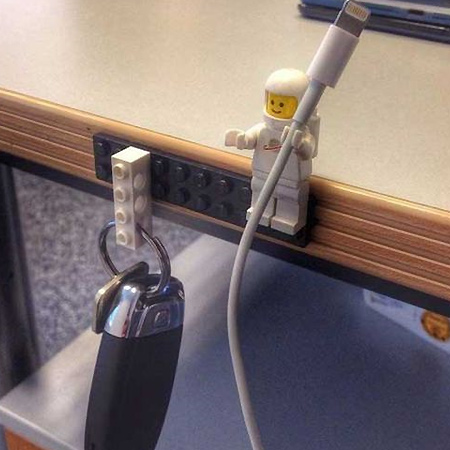 Corral clutter by using lego blocks and figures to hold cables and cords.