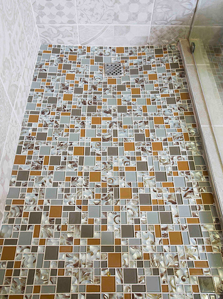 Mosaics installed in a shower are particularly popular. In this article TAL provides useful tips and guides on how to apply glass mosaics to a shower floor.