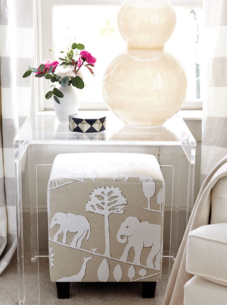 A pair of upholstered ottomans with sandy elephant print fabric complete the look. If you are handy with tools, making an upholstered storage ottoman for a bedroom shouldn't take you more than an hour to complete, and you can shop around for the best fabrics for the room setting.