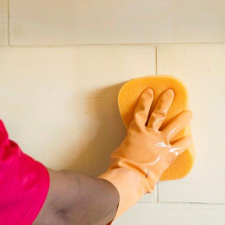 6. Wipe away any excess grout as you work with a damp (not wet) sponge. This is particularly important when a latex additive has been used. The sponge must be frequently rinsed in clean water, and should have rounded corners to avoid gouging out the grout.