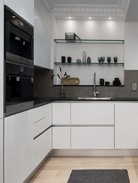 Replace old appliances with modern, reflective-finish appliances. Or add painted glass detailing for a modern touch