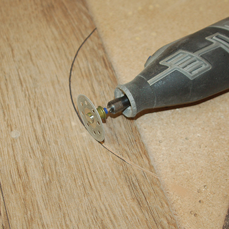 To cut out the profile I am using my Dremel 8200 MultiTool with diamond cutting disk. This cutting disk will cut through ceramic, porcelain and even natural stone tiles, although the latter make take a little longer