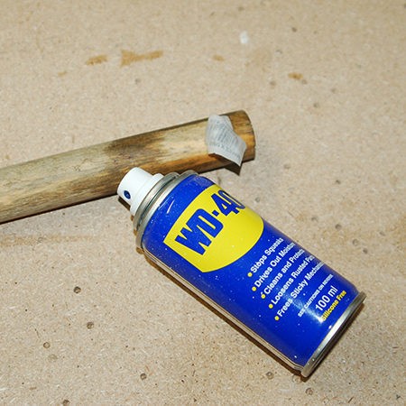 Sticky labels on pieces of wood are annoying and difficult to remove. I just discovered that a spray with WD-40 makes it so easy to peel off the labels, and it won't affect any stain or paint that you apply to the finish later on.