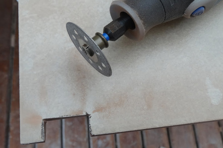 With the diamond cutting wheel you can cut curves or difficult shapes using your Dremel MultiTool. However, for cutting tiles invest in one of the higher speed models, such as the 8100, 8200 or Dremel 4000.
