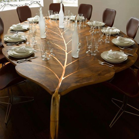 The 'Mulberry Table', by furniture designer John Makepeace, is one of a series of large 'leaf' tables in wood and polished bronze. All of the designs are rooted in a long-standing fascination with the properties of different timbers and the way technology and individual craftsmanship enable new possibilities.