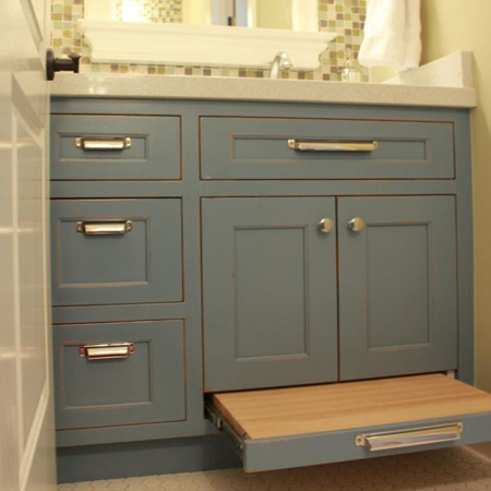 Fit a pullout step into a bathroom vanity to make it easier for a child to reach the bathroom sink