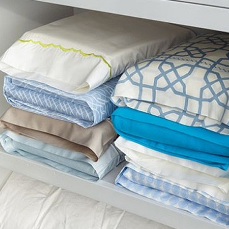 Keep a closet organised by slipping bed linen, duvets and sheets inside a pillowcase