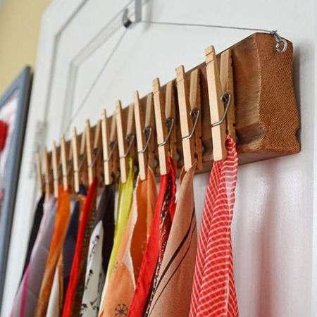 A scrap piece of wood, glue on some pegs, and you have an instant way to store your scarves.