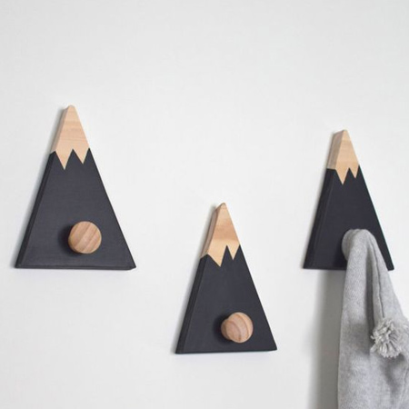 Combine small scraps, pine knobs and craft paint to make unique coat hangers for a home. Use picture hangers or keyhole brackets to mount onto the wall.