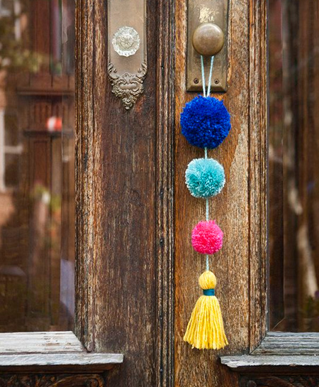 Colourful pom-poms are an inexpensive way to add a fun element to your home decor. You don't need special skills to make pom-poms and you can make them in a variety of sizes.  