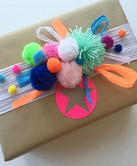 Here's another fun festive idea. Use colourful pom-poms to decorate Christmas gifts