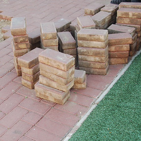 GOOD TO KNOW: If you are going to be re-using the paving bricks, clean them off and stack neatly to one side.