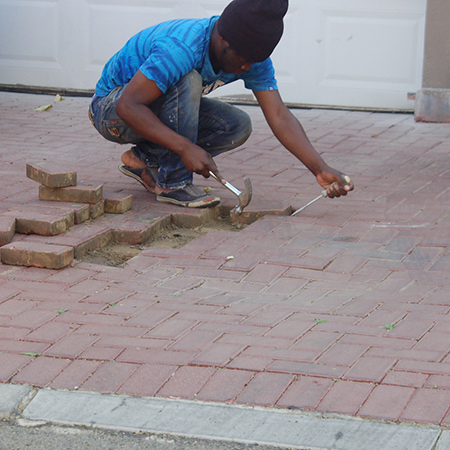 Repairing the dip in the paving meant that the paving bricks around the area had to be removed. A flathead screwdriver allows you to lever and lift out the first paving brick.
