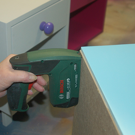 HOME-DZINE | DIY Furniture - Secure the back with a Bosch Tacker and staples, or use a hammer and panel pins. Remember to angle the panel pins when hammering in to better hold the backing in place.
