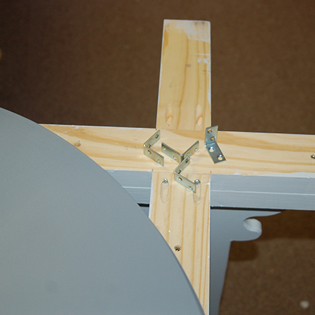 13. Attach the tabletop to the base with steel angle braces and screws.