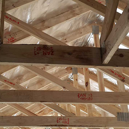 Truss hangers not installed due to a mix-up with a different section and detail.