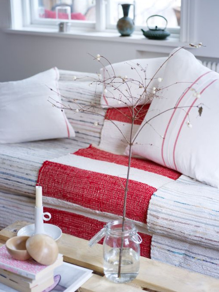red and white textiles, wooden furniture and minimal decoration