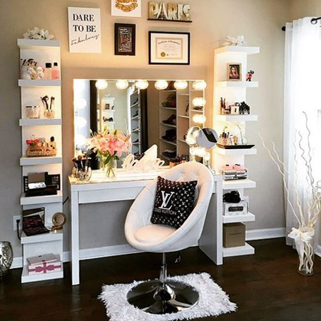 One vanity design that has been popping up quite a lot are the ones shown above and below. This design incorporates a trendy desk, some basic shelf units and a mirror framed with LED lights.  