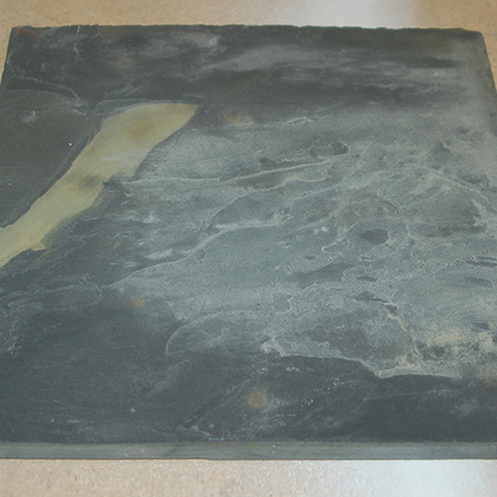 Slasto and slate tiles are flaky in their natural state, when you buy them. When left untreated, the flaky layers become brittle and it's easy for chips and large flakes to break off from the surface.