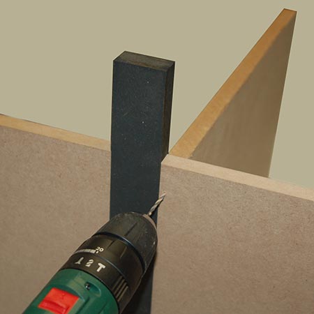 Made from a small block of 16mm SupaWood and two pieces of 3mm hardboard, the jig slips over 16mm board to show where the edge is located - making it easier to know where to drill pilot holes on the outside.