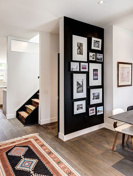 Sure to catch attention, an undiluted black wall provides the perfect canvas for a wall gallery and you don't have to worry about overdoing it with black.