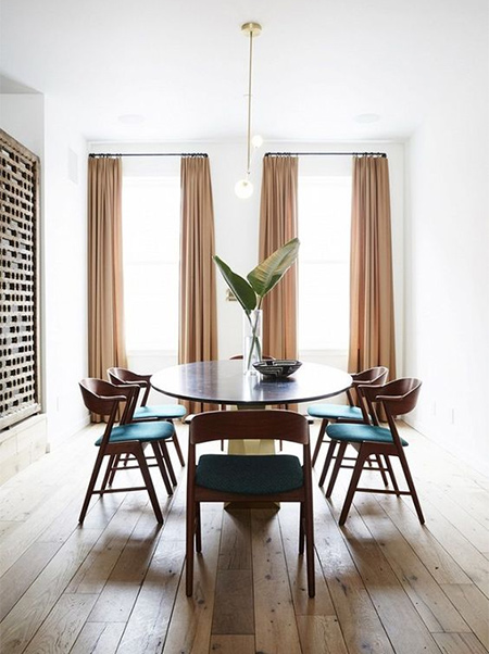 Perfect example of how curtains up to the ceilling make a small dining room appear much larger than it is.