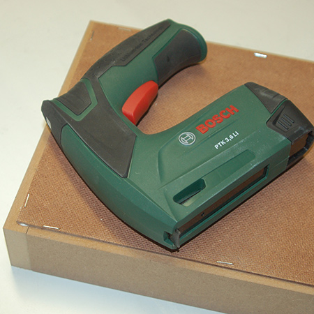 Cut the backing board to fit and staple in place with the Bosch Tacker. If you often do project that require stapling, the Bosch Tacker is definitely a tool to consider. It doesn't require a lot of pressure to operate, so there is less strain on your hand.