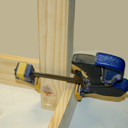 4. Apply wood glue to the top of the leg and clamp tightly into the corner of the frame.