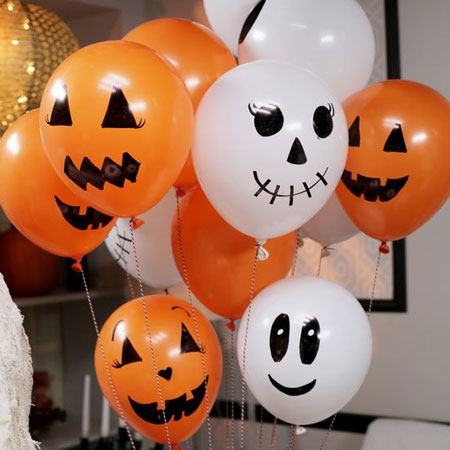 HOME-DZINE | Halloween Crafts - Stock up on orange and white balloons and use a permanent marker to draw scary faces on them. If you don't want to go to the expense of filling with helium to let them float, secure on thin sticks or dowels.