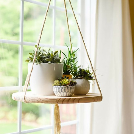 Re-purpose a pine cutting board, or buy laminated pine to make your own circular shelves. Wrap these with thick string, coir or sisal rope to make a pretty hanging shelf for displaying small potted plants