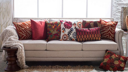 Earth-toned colours and warm reds spice up a living room sofa and introduce a cosy atmosphere to the room.