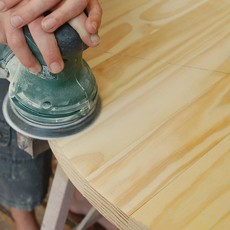 5. Sand the top of the table smooth. It's not always guaranteed that the boards will be one hundred percent level, so start with 120-grit to remove uneven edges and then sand smooth with 180-grit.