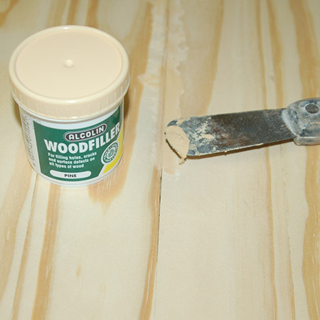 Choose a tinted wood filler that matches how your table will be finished if you are staining. For this table I'm using pine wood filler. Let dry and then sand smooth