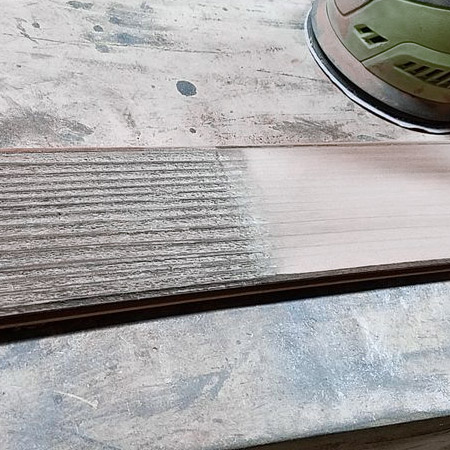 Using 120-grit sandpaper to achieve a reasonably smooth finish, and from there you can leave as is for a rustic table, or sand further with 180- or 240-grit sandpaper.
