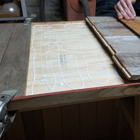 As mentioned above, we're using reclaimed tongue and groove to clad our table. These were arranged in a vertical / horizontal design that was glued on top of the plywood - and inside the frame.