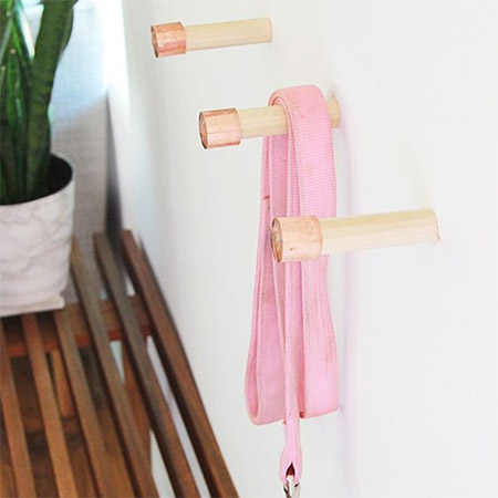 HOME-DZINE | Copper Tube DIY - Another copper tube project by Laurel is to add a copper end cap to wooden dowels to make hangers. If you don't have drywall for mounting the hangers, secure them onto a backing board to hang on the wall.